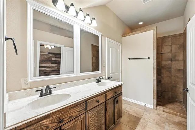 a bathroom with a sink double vanity and a mirror