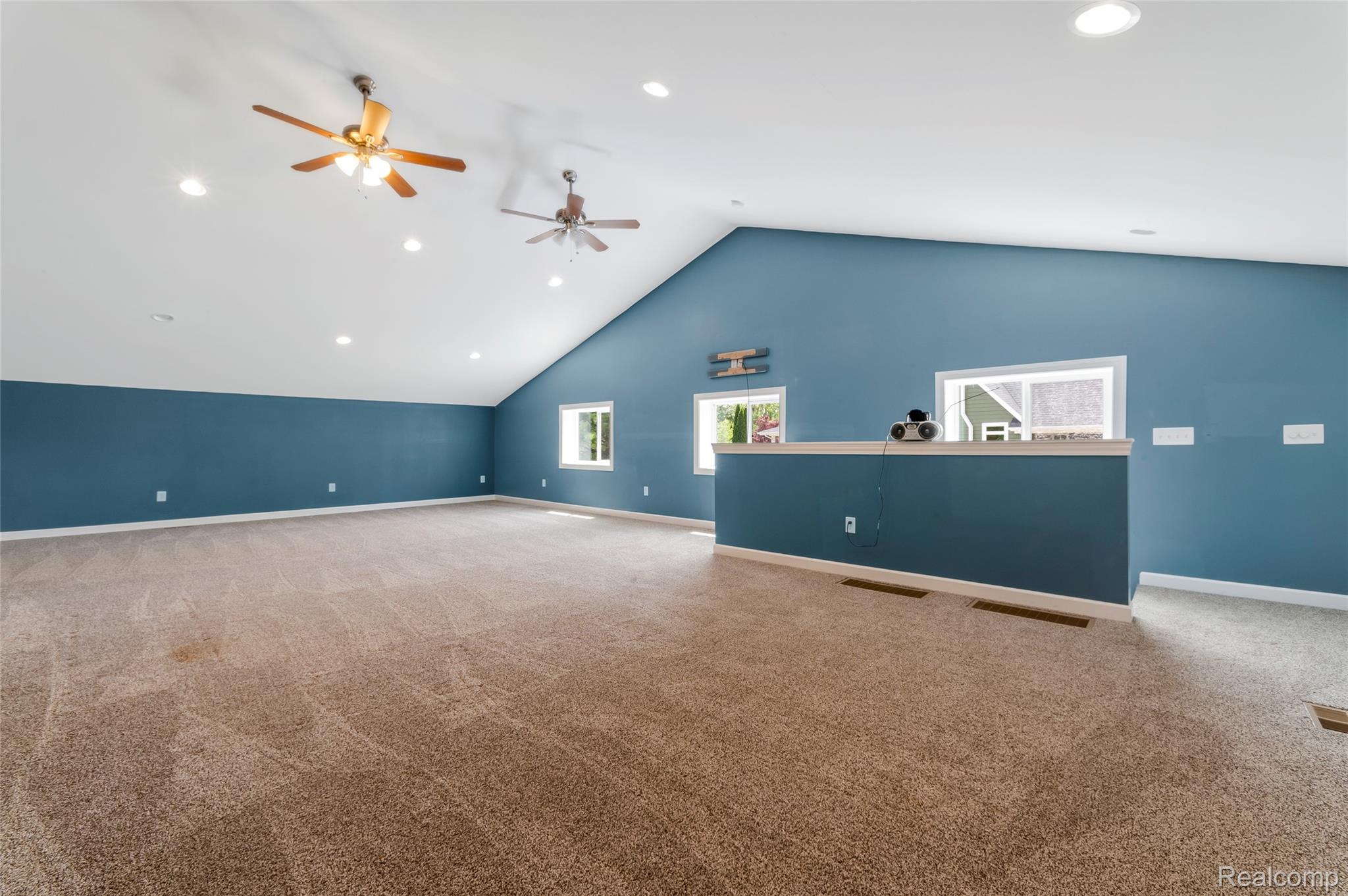 13085 Rohn Road Fenton, MI 48430 - Photo 33 of 52 Unfurnished living room featuring recessed lighting, light carpet, and ceiling fan in pole barn