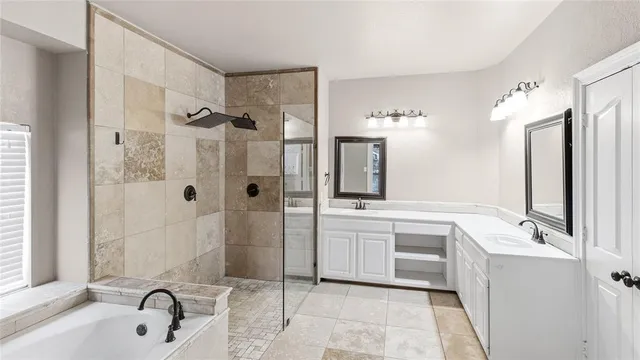 a bathroom with a tub sink and mirror