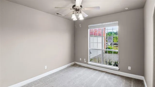 a view of room with window and ceiling fan