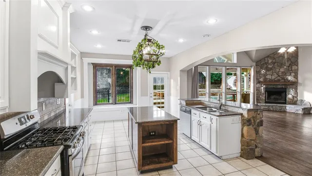 a kitchen with stove and cabinets