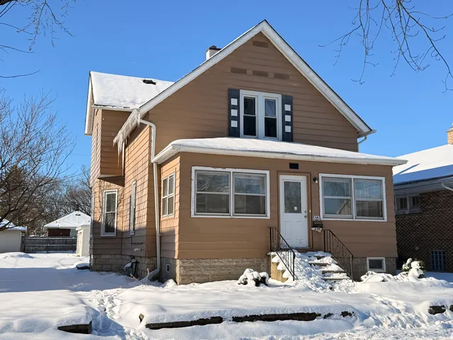 a front view of a house with snow