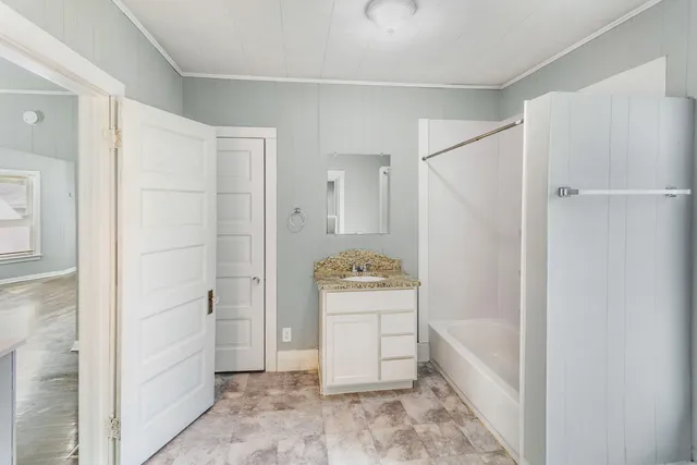a bathroom with a bathtub and shower