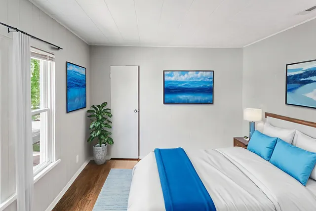 a bedroom with a bed and a potted plant