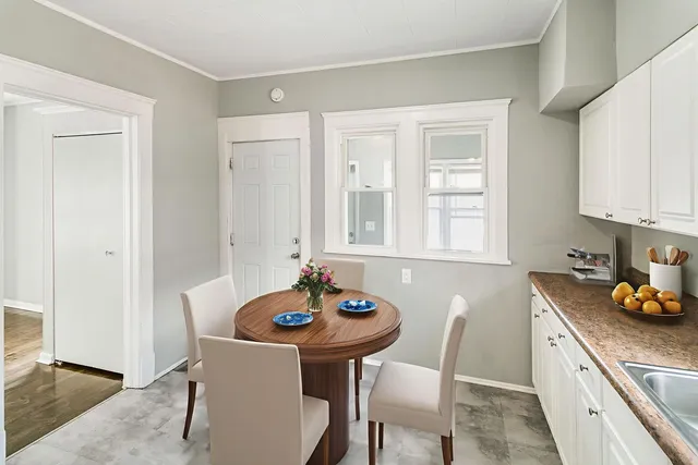 a kitchen with stainless steel appliances kitchen island granite countertop a sink and white cabinets