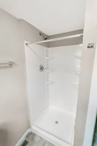 a bathroom with a glass shower door