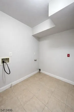 a view of a room with wooden floor and a ceiling fan