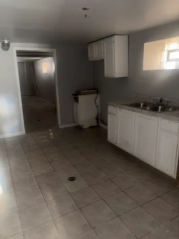 a kitchen with stainless steel appliances a sink stove and cabinets