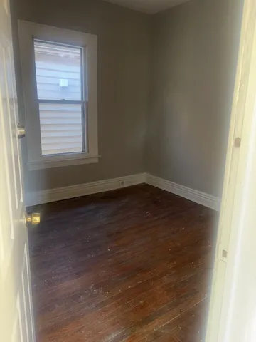 a view of room with window and hardwood floor