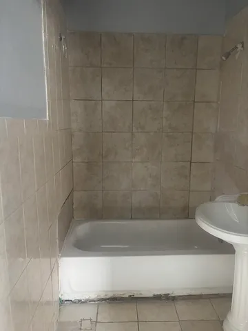 a bathroom with a bathtub and a shower