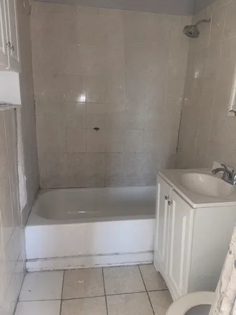 a bathroom with a bathtub and shower