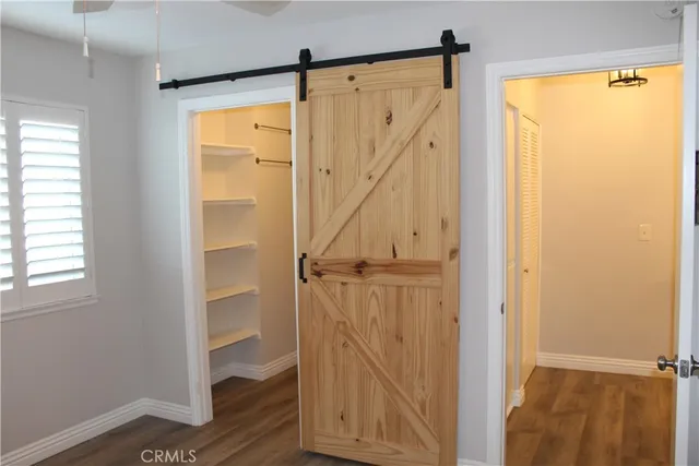 a view of walk in closet with empty racks