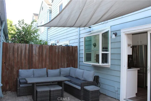 a backyard of a house with a couch and chairs