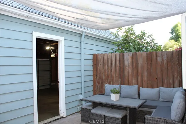a backyard of a house with barbeque oven table and chairs
