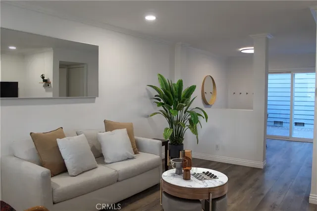 a living room with furniture and a potted plant
