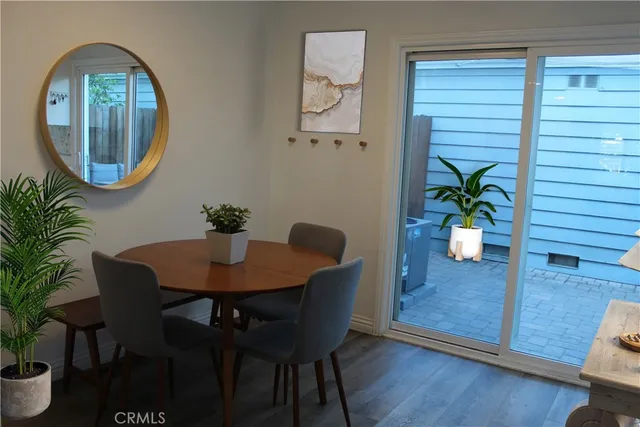 a dining room with furniture and a potted plant