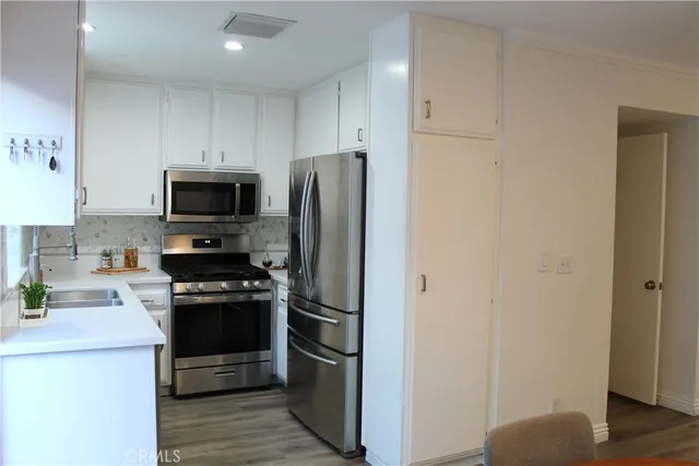 a kitchen with stainless steel appliances a refrigerator stove and microwave