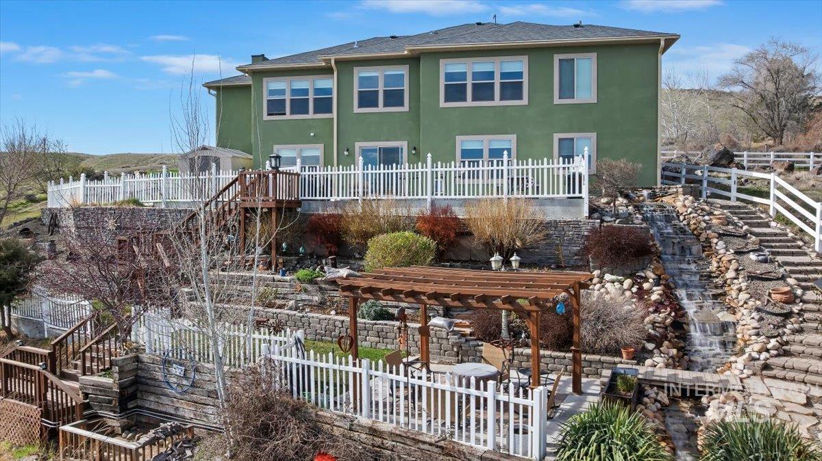 40 Bell Rapids Road Hagerman, ID 83332 - Photo 34 of 50 Rear view of property featuring a patio area, a fenced backyard, stucco siding, and a pergola