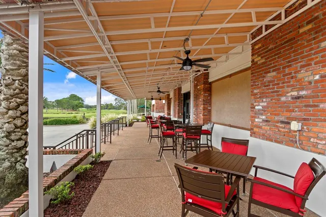 a view of a patio with a table chairs and a ocean view