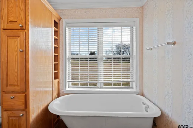 a white bath tub sitting next to a window