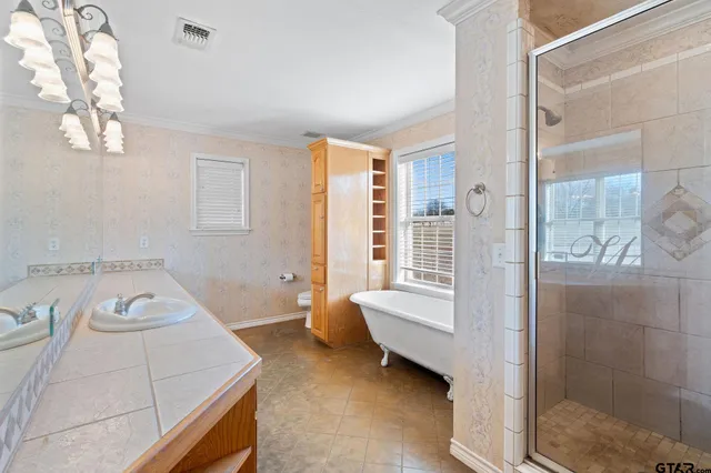 a bathroom with a tub sink and shower