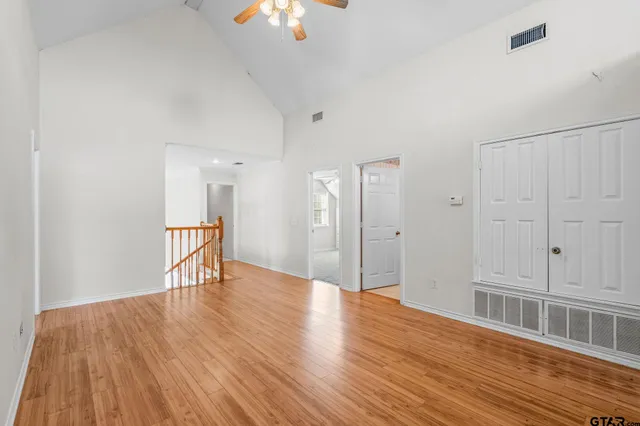 a view of an empty room with wooden floor