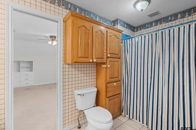 a bathroom with a toilet and shower