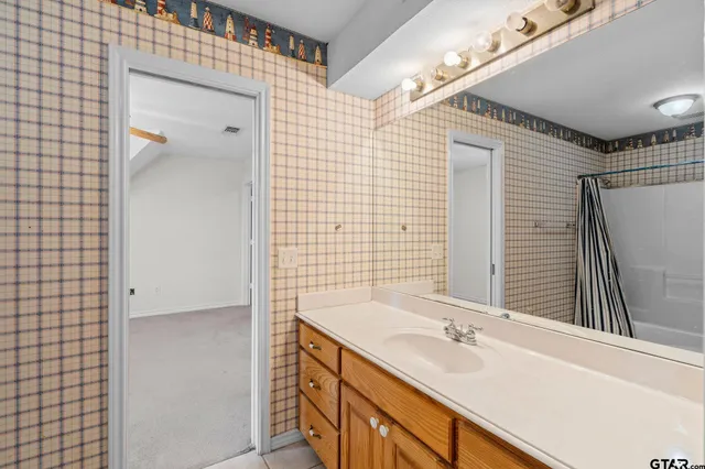 a bathroom with a double vanity sink and mirror