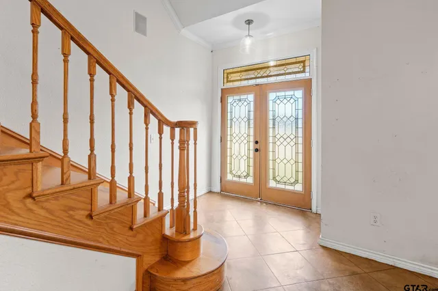 a view of entryway and hall with wooden floor