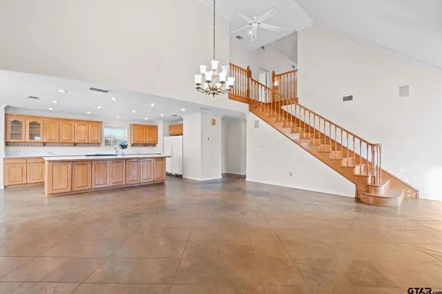 a view of a living room with kitchen view and wooden floor