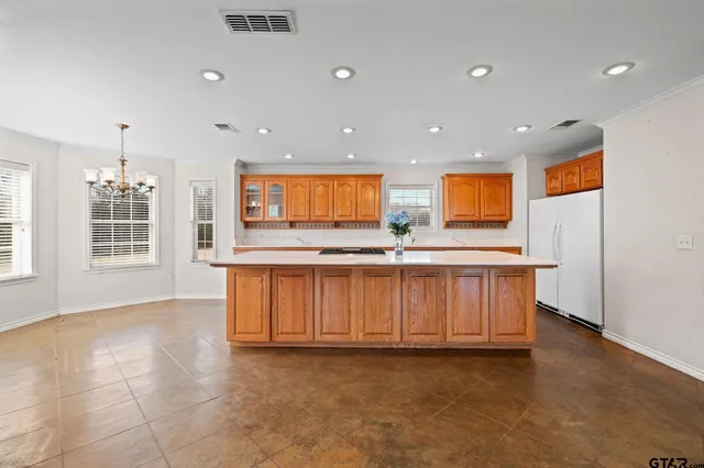 a view of kitchen with stainless steel appliances granite countertop a stove a sink and a microwave