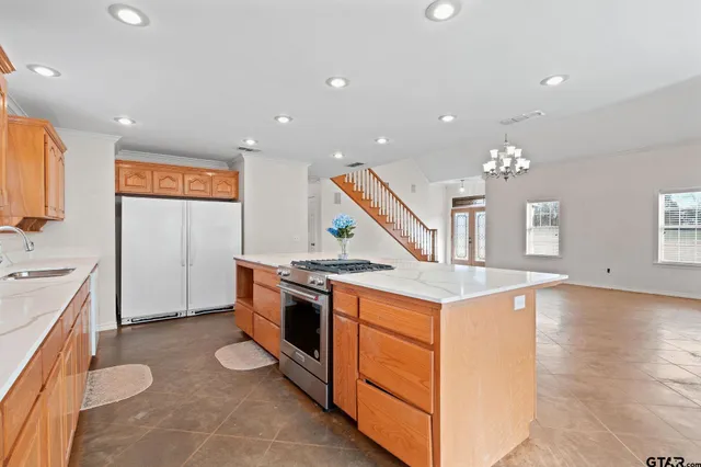 a kitchen with a stove a sink and a refrigerator