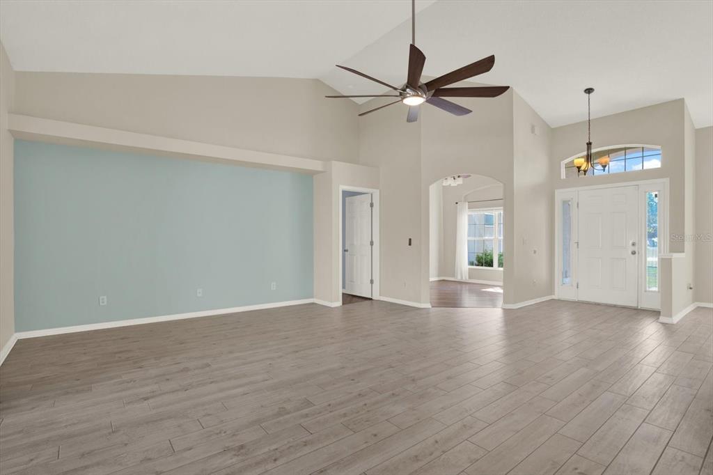 4400 Dior Road Spring Hill, FL 34609 - Photo 11 of 37 wooden floor in an empty room with a window