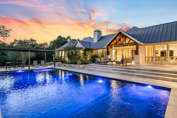 a view of a house with pool and wooden floor