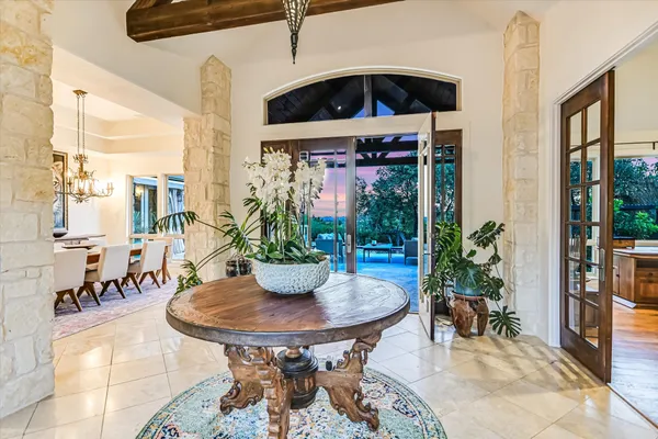 a dining room with furniture and a potted plant