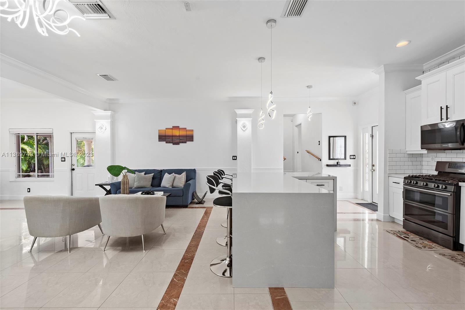 2201 Southwest 84th Avenue Miami, FL 33155 - Photo 11 of 33 a living room with kitchen island furniture and a flat screen tv