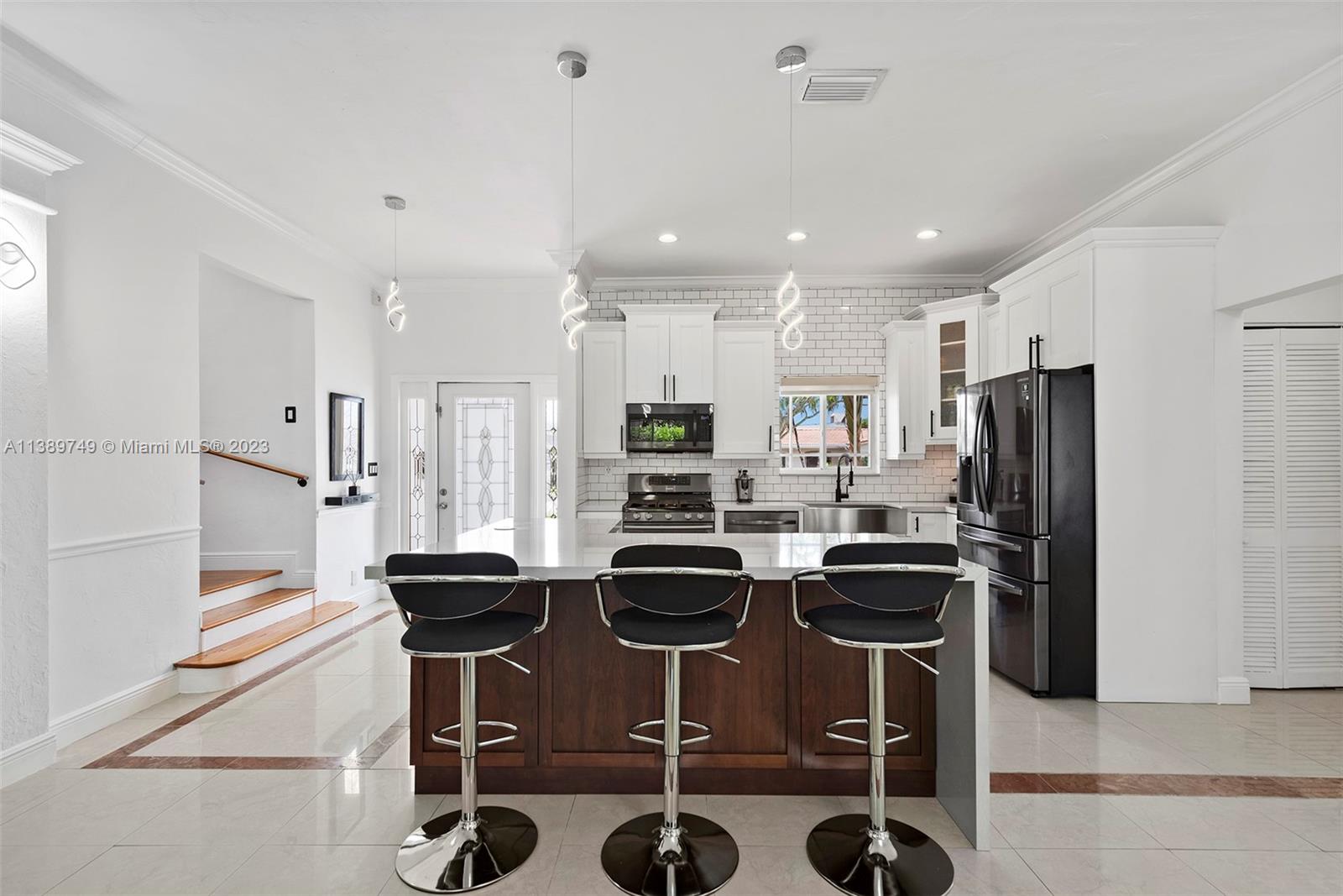 2201 Southwest 84th Avenue Miami, FL 33155 - Photo 12 of 33 a kitchen with stainless steel appliances kitchen island granite countertop a refrigerator and a stove top oven
