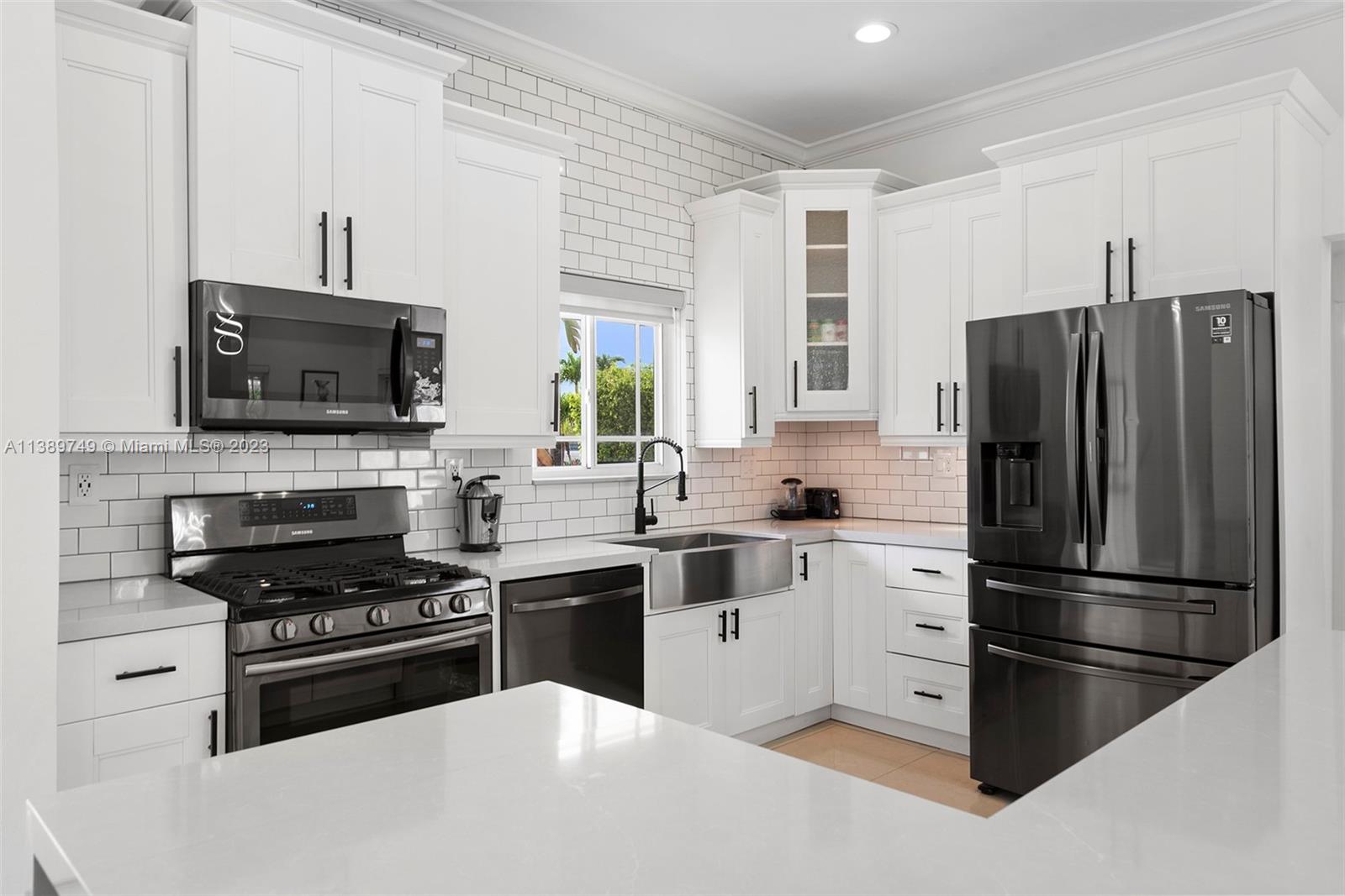 2201 Southwest 84th Avenue Miami, FL 33155 - Photo 13 of 33 a kitchen with granite countertop a refrigerator stove and microwave