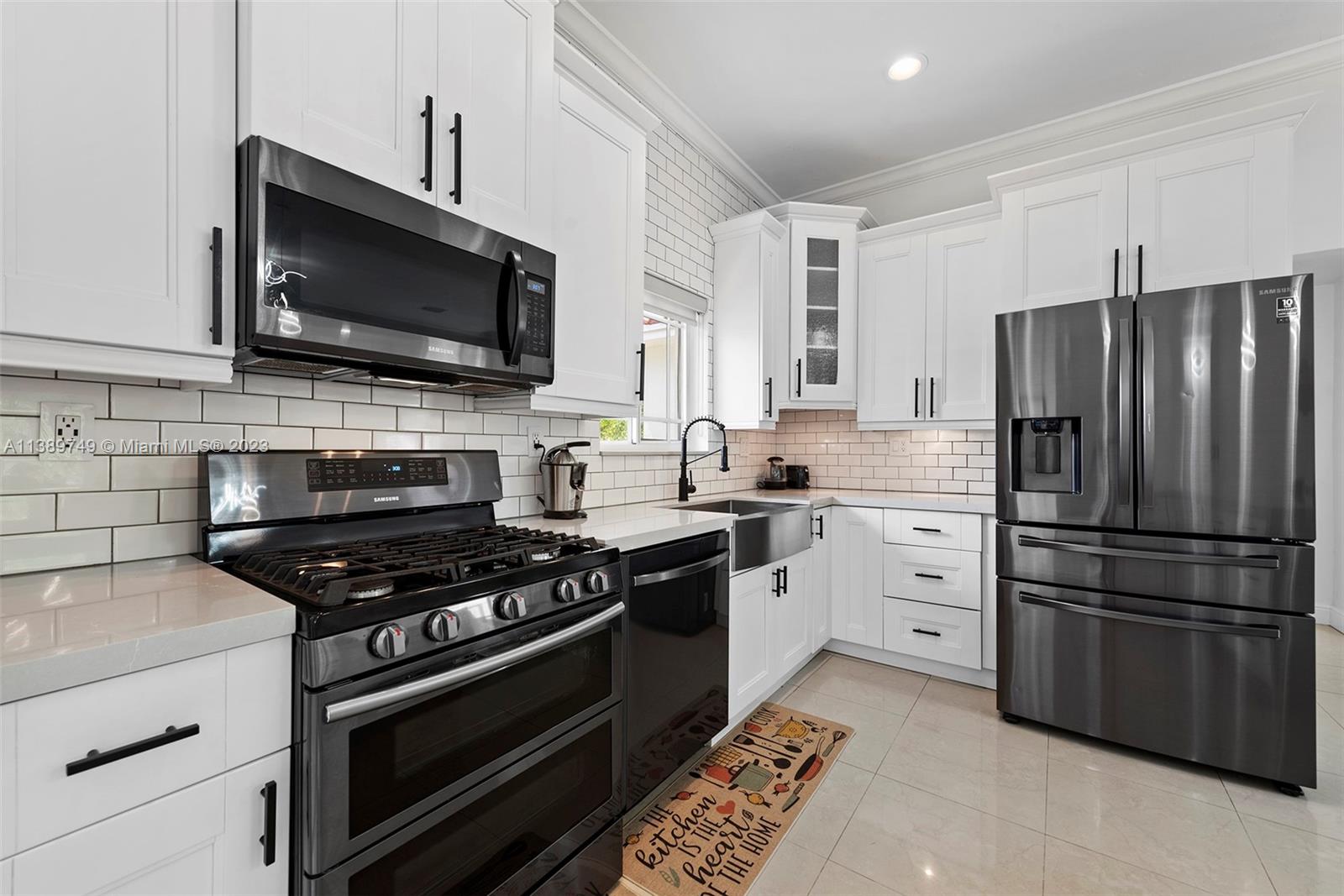 2201 Southwest 84th Avenue Miami, FL 33155 - Photo 16 of 33 a kitchen with cabinets stainless steel appliances and wooden floor