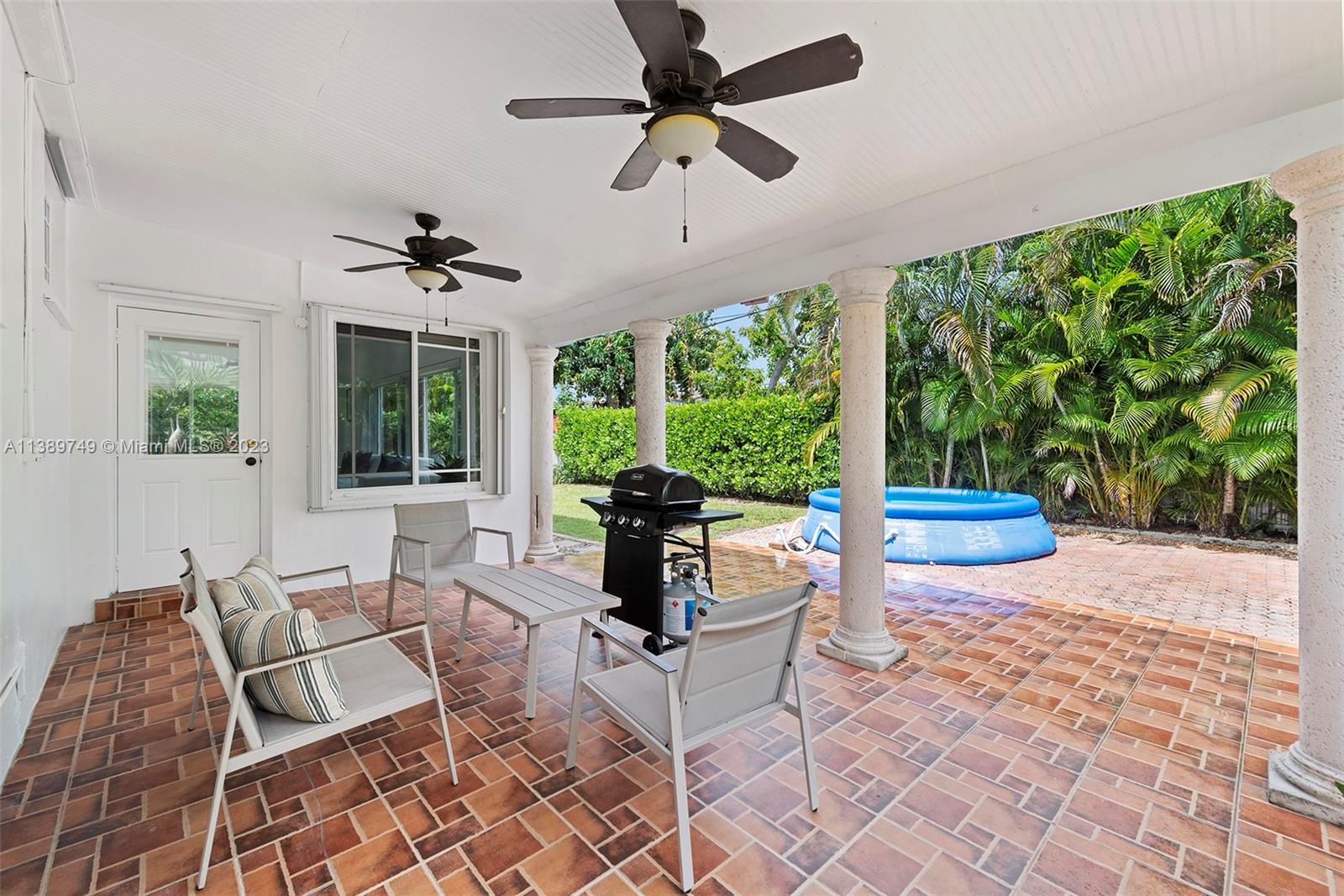 2201 Southwest 84th Avenue Miami, FL 33155 - Photo 30 of 33 a living room with patio furniture and a floor to ceiling window