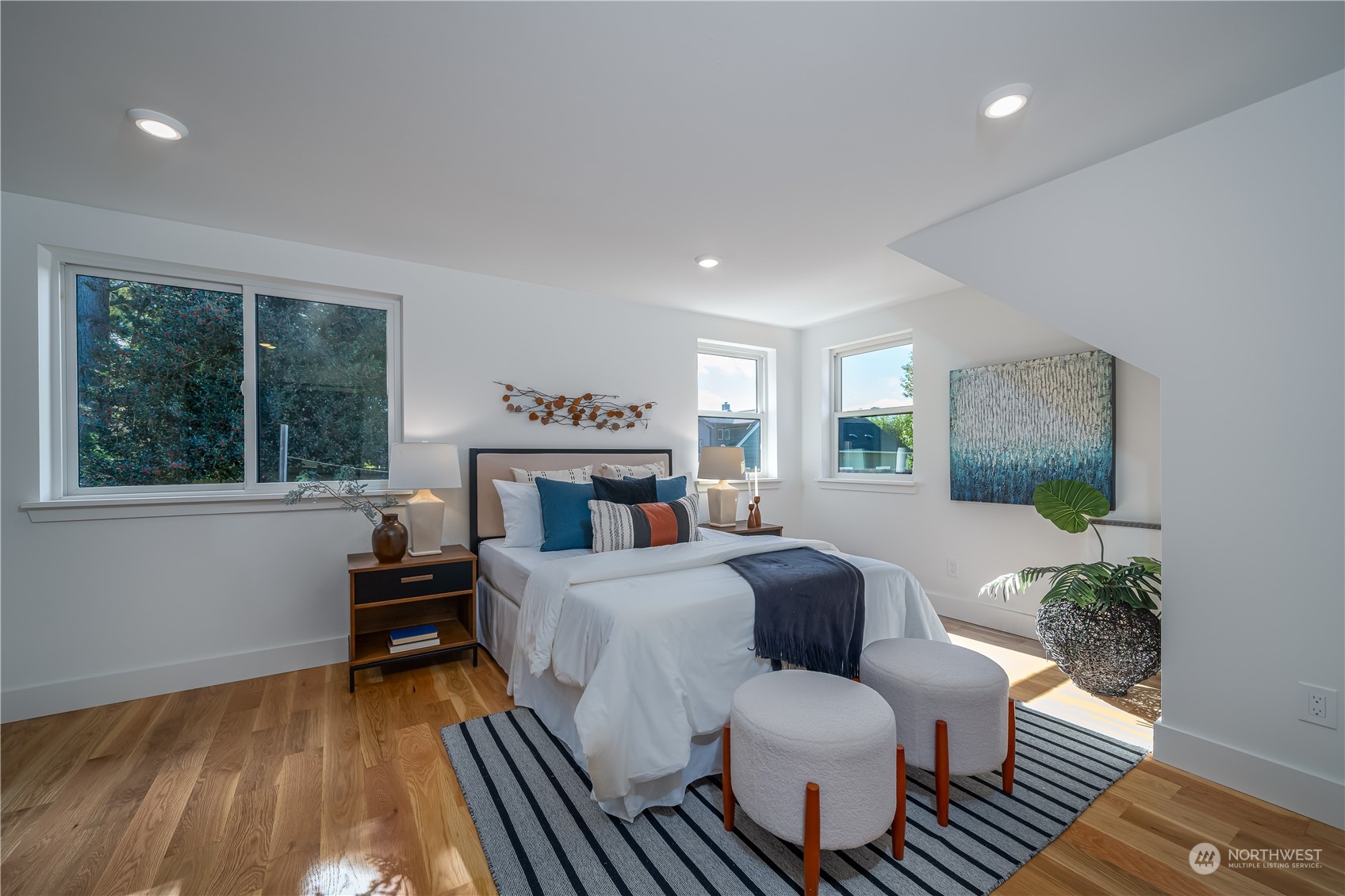 3919 Southwest Monroe Street Seattle, WA 98136 - Photo 19 of 40 a bedroom with a bed and wooden floor
