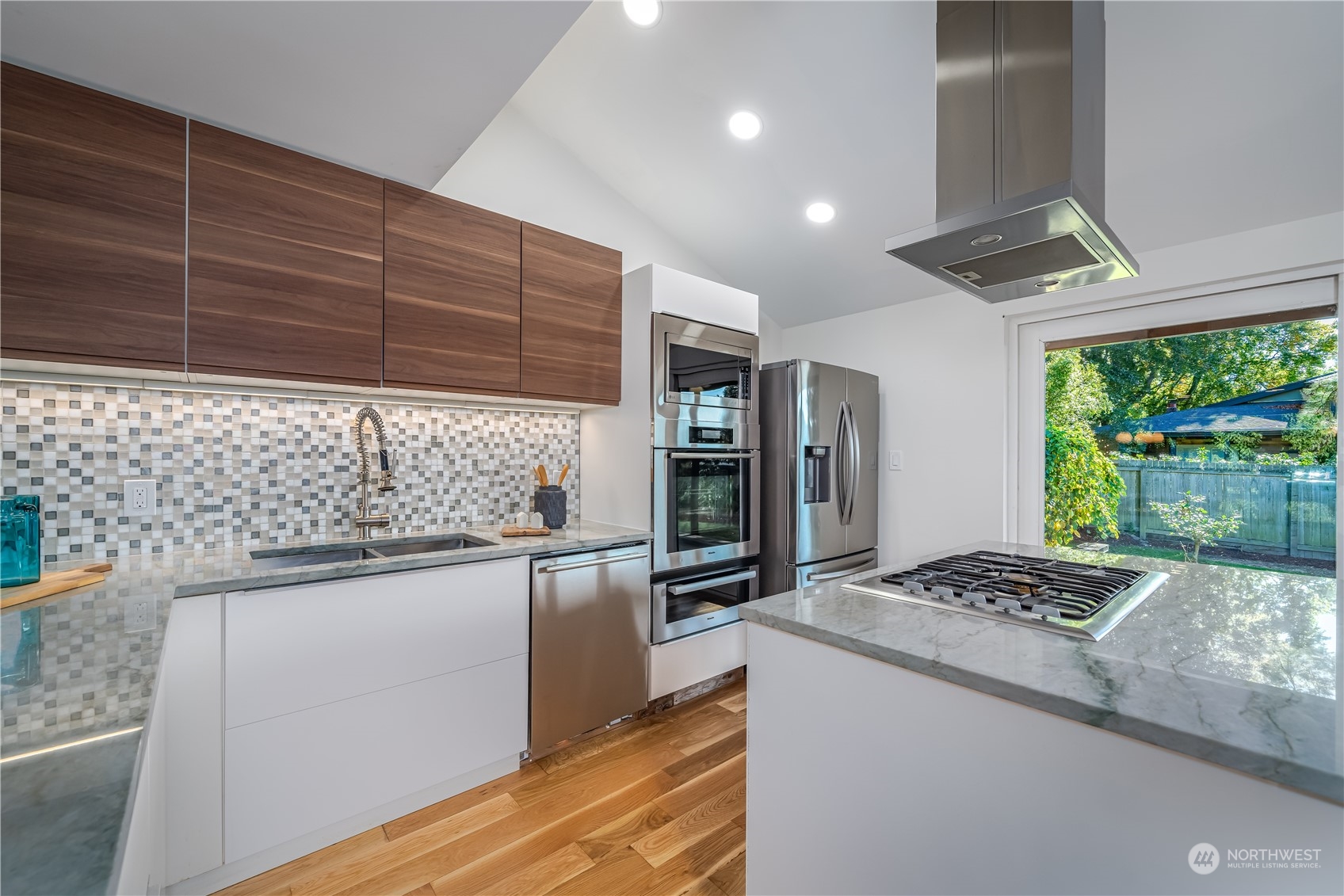 3919 Southwest Monroe Street Seattle, WA 98136 - Photo 7 of 40 a kitchen with stainless steel appliances granite countertop a sink stove and refrigerator