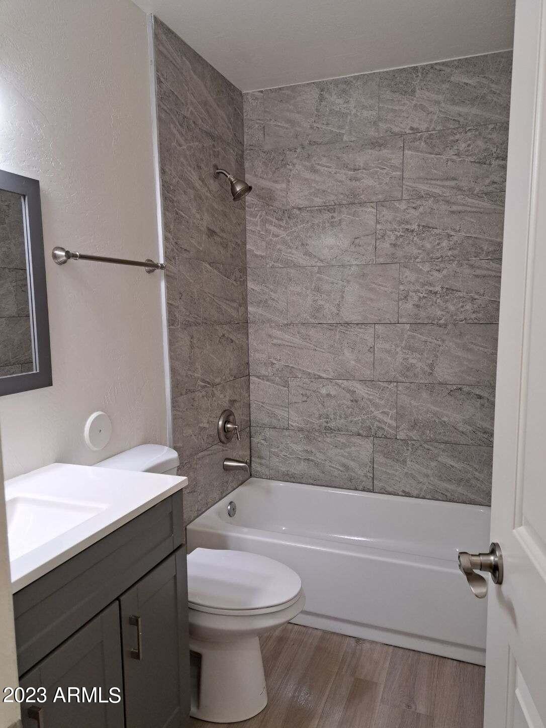 6713 East Cheery Lynn Road, Unit 4 Scottsdale, AZ 85251 - Photo 11 of 12 a bathroom with a sink a toilet and shower