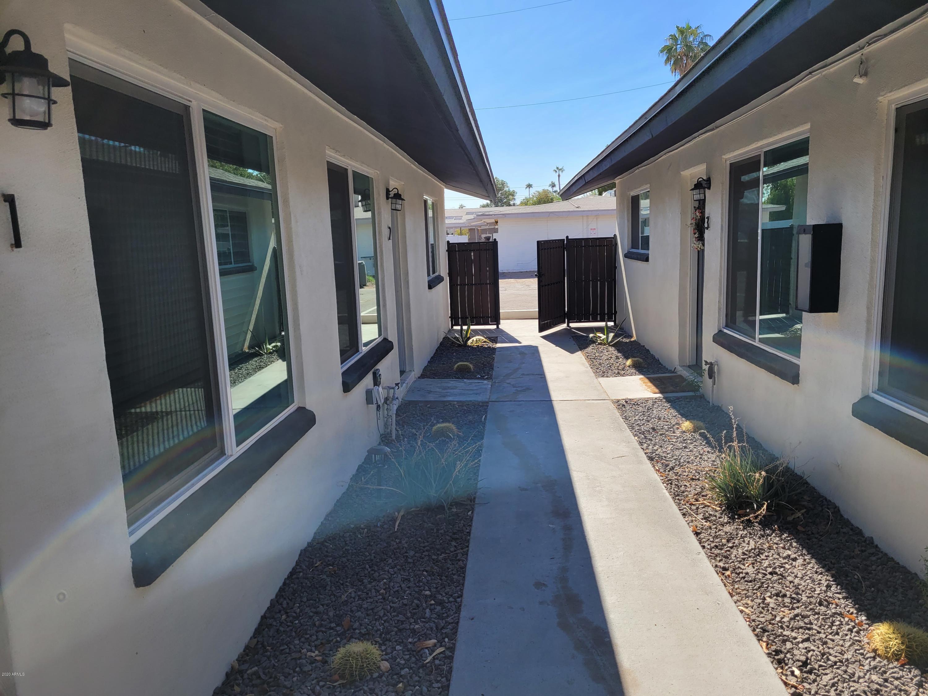 6713 East Cheery Lynn Road, Unit 4 Scottsdale, AZ 85251 - Photo 5 of 12 a hallway with wooden floor and glass door