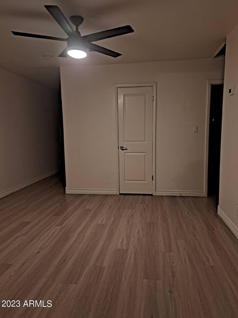 6713 East Cheery Lynn Road, Unit 4 Scottsdale, AZ 85251 - Photo 8 of 12 a view of an empty room with wooden floor