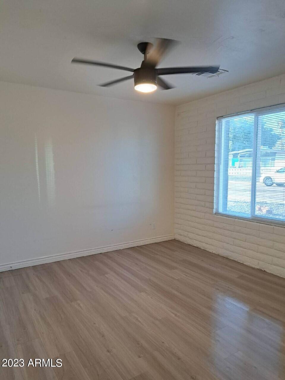 6713 East Cheery Lynn Road, Unit 4 Scottsdale, AZ 85251 - Photo 9 of 12 wooden floor in an empty room with a window