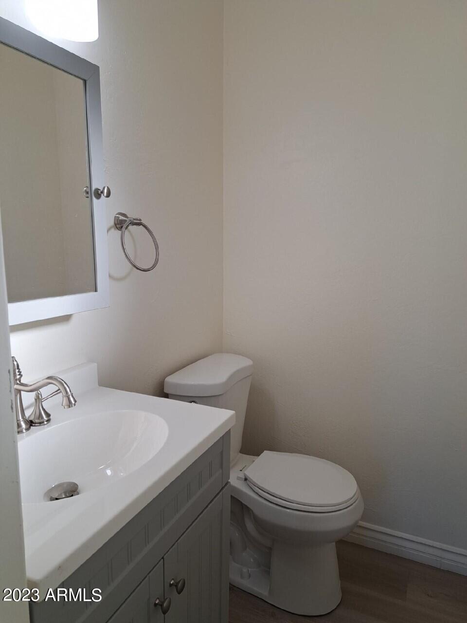 6713 East Cheery Lynn Road, Unit 4 Scottsdale, AZ 85251 - Photo 10 of 12 a bathroom with a toilet sink and mirror