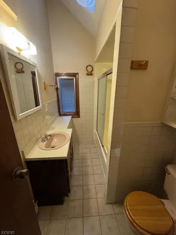 a bathroom with a sink a toilet and a mirror