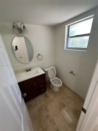 a spacious bathroom with a toilet sink and mirror