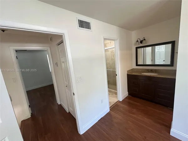 a view of hallway with wooden floor